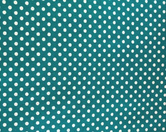May include: Teal fabric with a repeating pattern of white polka dots. The dots are evenly spaced across the surface, creating a classic and playful design. The fabric has a soft, matte finish.
