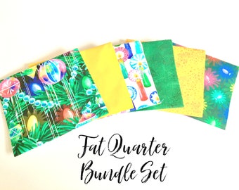 May include: A set of six fat quarter fabric squares featuring a Christmas theme. The fabrics include a green print with ornaments and lights, a yellow solid, a white print with candles, a green solid, a yellow print with dots, and a green print with flowers.