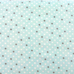 May include: A fabric with a light blue background, covered in a pattern of white and gray polka dots. The dots are evenly spaced and create a playful, yet classic design. This fabric is suitable for various sewing projects.