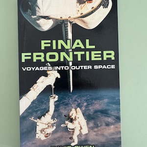 May include: A paperback book titled Final Frontier: Voyages Into Outer Space by David Owen. The cover features a photograph of two astronauts in white space suits performing a spacewalk against the backdrop of Earth and a space shuttle.