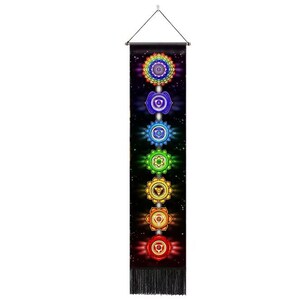 May include: A vertical wall hanging featuring seven colorful chakra symbols against a black starry background. The symbols are arranged vertically, each with a unique design and color, ranging from red to violet. The bottom has a fringe.