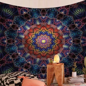 May include: A vibrant tapestry featuring a detailed mandala design. The artwork showcases a central floral pattern in shades of orange, yellow, and blue, surrounded by intricate geometric shapes in deep blues and purples. The tapestry is a decorative wall hanging.