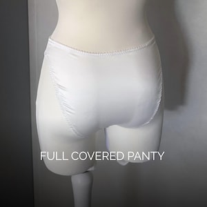 May include: A pair of white satin knickers with a high-cut leg design and elasticated trim along the waist and leg openings. The garment features a smooth, solid white finish and includes the text FULL COVERED PANTY printed in white at the bottom.