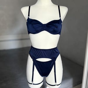 Burgundy satin lingerie set with sheer bra, mesh panty, garter belt, and matching thong. This romantic lingerie is perfect as a bridal gift, bridal shower gift, or honeymoon lingerie, adding elegance to self care gifts or custom lingerie collections. Designed as seductive lingerie with a floral bralette style, it works as see through bras, sheer thong, or babydoll lingerie. A versatile piece of wedding lingerie, bride lingerie, lace lingerie, and ultra sexy lingerie.
