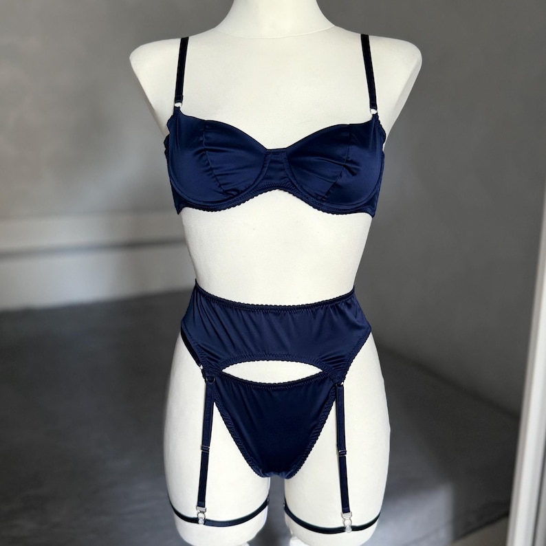 Burgundy satin lingerie set with sheer bra, mesh panty, garter belt, and matching thong. This romantic lingerie is perfect as a bridal gift, bridal shower gift, or honeymoon lingerie, adding elegance to self care gifts or custom lingerie collections. Designed as seductive lingerie with a floral bralette style, it works as see through bras, sheer thong, or babydoll lingerie. A versatile piece of wedding lingerie, bride lingerie, lace lingerie, and ultra sexy lingerie.