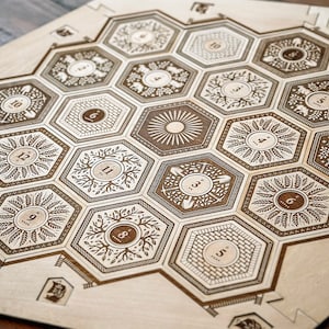 May include: A wooden game board with a hexagonal grid pattern. Each hexagon has a unique design and a number from 1 to 12. The board is made of light wood with a brown stain.