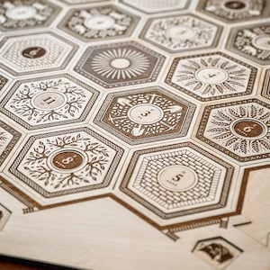 May include: A wooden game board with hexagonal tiles featuring different designs and numbers. The tiles are arranged in a honeycomb pattern. The board is made of light brown wood and has a natural finish.