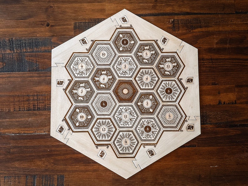May include: A wooden hexagonal game board with a honeycomb pattern. The board has numbers 1 through 12 around the edge and a sun in the center.