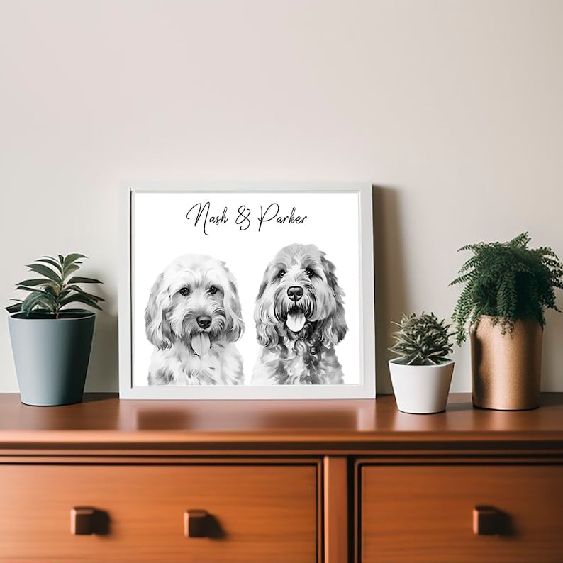 May include: Black and white portrait of two dogs, Nash and Parker, with a white background.