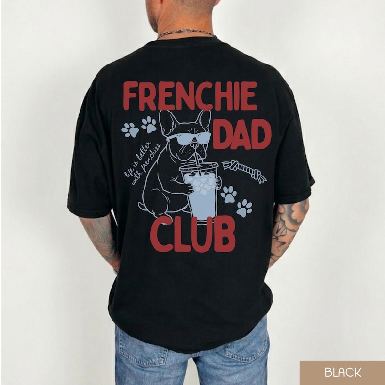 May include: Black t-shirt with a graphic that reads "FRENCHIE DAD CLUB" in red and white. The graphic features a French Bulldog wearing sunglasses and drinking from a cup. Paw prints and the phrase "life is better with frenchies" are also included.