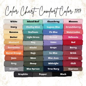 May include: A colour chart showing Comfort Colors t-shirt shades. The chart includes colours like white, ivory, banana, mustard, terracotta, burnt orange, yam, grey, and granite. Other colours include island reef, chambray, blossom, and crunchberry.