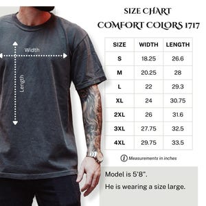 May include: A dark grey Comfort Colors 1717 t-shirt with a size chart. The chart lists sizes S to 4XL, with measurements in inches. The model is 173 cm tall and wearing a size large.