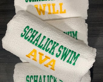May include: Four white towels with green embroidery that reads "Schalick Swim" and a yellow embroidered name on each towel: Will, Ava, Eve.