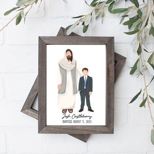 May include: A framed illustration of Jesus Christ standing next to a young boy in a suit. The text below reads "Josh Costleberry Baptized August 5, 2023".