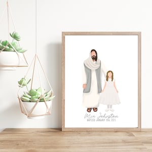 May include: A framed print featuring an illustration of a figure with a long beard and a girl in a white dress. The text at the bottom reads "Mia Johnston Baptized January 8th 2021". Two hanging planters with succulents are also visible.