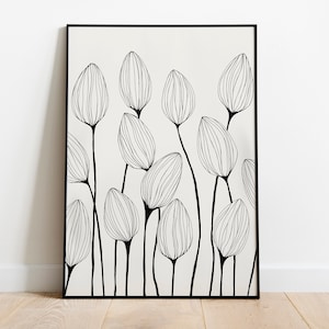 Può includere: Stampa in bianco e nero di fiori stilizzati in linea, in una cornice nera. La stampa presenta un design minimalista su sfondo bianco.