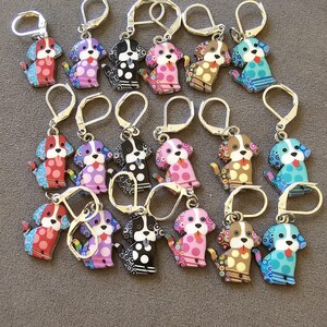 Enameled Dog Stitch Markers with a ring styled clasp for knitters mostly.  They may also be used as earrings.  The clasps are silver in color but look more gold in the photo. There is a lot of detail in each dog and  they are very cute and happy.