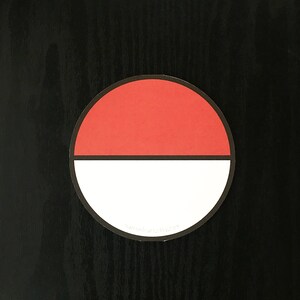 May include: A circular sticker featuring a red top half and a white bottom half, separated by a horizontal black line. The sticker has a thin black border and includes the small white text natronicart.etsy.com at the bottom.