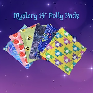 May include: A collection of square potty pads featuring various patterns including strawberries, bees, space, butterflies, and colorful shapes. The text Mystery 14" Potty Pads is displayed at the top. Each pad is square-shaped with stitched edges.