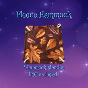 May include: A square fleece hammock featuring a brown background with a pattern of orange, yellow, and brown autumn leaves. The hammock has four white fabric loops at the corners with metal clips. Text reads: Fleece Hammock, Hammock stand is NOT included.