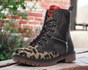 May include: Black leather boots with a leopard print design on the toe and a skull and crossbones design on the top of the boot. The boots have a zipper on the side and a lace-up closure.
