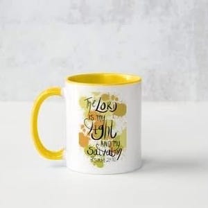 May include: White ceramic mug with a yellow rim and handle. The mug features a watercolour-style design with the text "The Lord is my light and my salvation" and the scripture reference "Psalm 27:1".