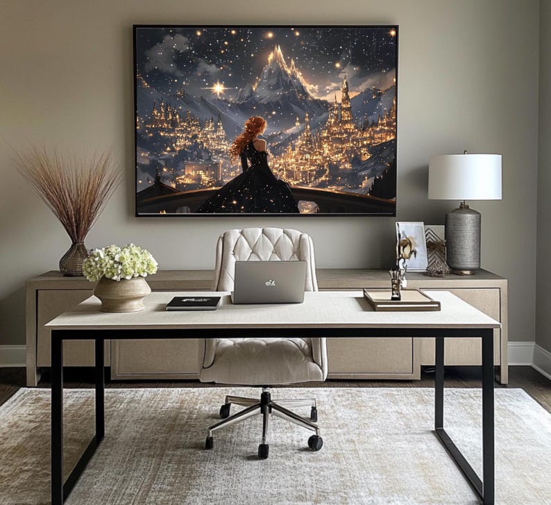 May include: A home office with a white desk and black metal legs. A white office chair with a tufted back sits in front of a laptop computer. A framed print of a woman standing in a fantasy city with a starry sky hangs on the wall above the desk. A lamp with a white shade and a silver base sits on a side table.