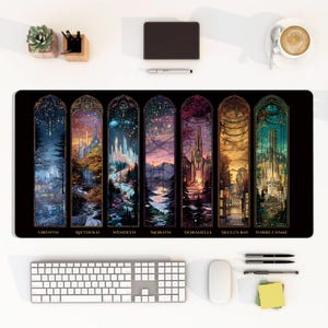 May include: A rectangular desk mat featuring seven vertical panels with fantasy cityscapes, labeled Orynth, Rifthold, Wendlyn, Morath, Doranelle, Skull's Bay, and Torre Cesme. The artwork displays varied color palettes including deep blues, oranges, and greens.