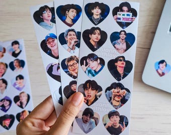 May include: A set of white sticker sheets featuring multiple heart-shaped portraits of various young men. The images show different facial expressions, poses, and outfits, including one sticker with text that reads TO ME YOU ARE PERFECT.