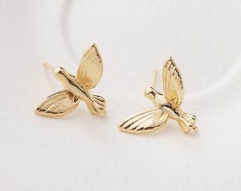 May include: A pair of gold-colored stud earrings. Each earring is shaped like a bird in flight, with detailed wing and tail feather designs. The earrings have a post and backing for secure wear.