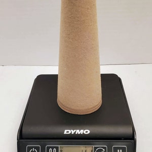 May include: A brown paper cone on a black digital scale that reads 4.1 kg or 9.0 lb. The scale has a tare button, a kg/lb button, and a hold button.