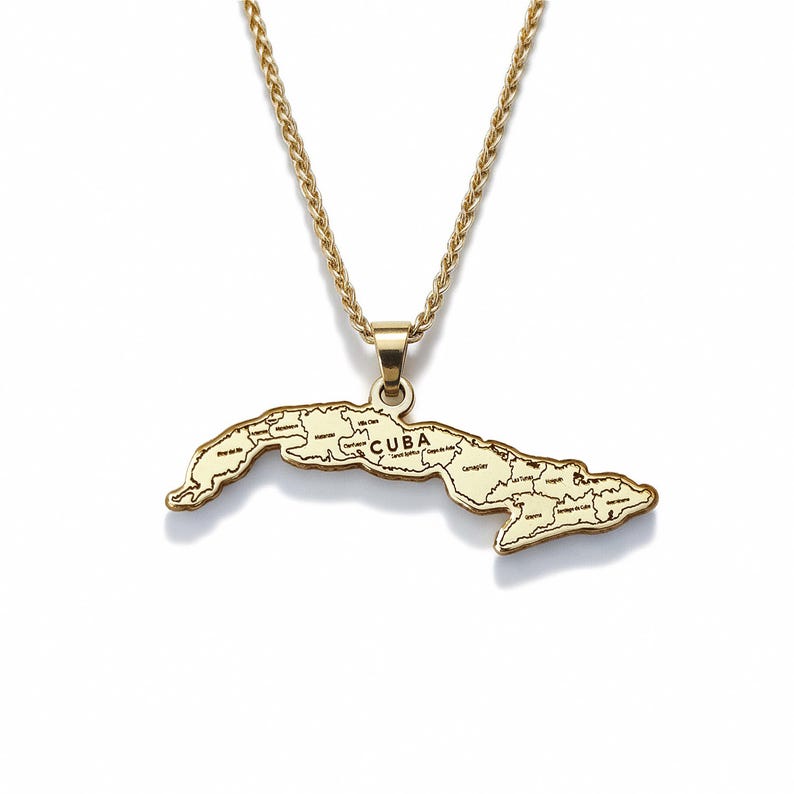 A gold-colored pendant necklace with a map of Cuba on it.