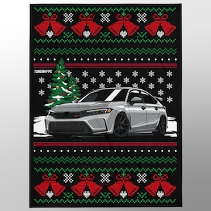 May include: Black blanket with a Christmas sweater design. The blanket features a silver car graphic, a Christmas tree, snowflakes, and red bells. The text "TUNERHYPE" is visible on the blanket.