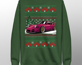 May include: Green sweatshirt with a Christmas-themed design. The design features a magenta sports car, Christmas trees, snowflakes, and red bells. The text "TUNEINTYPE" is visible on the bottom right of the design.