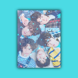 May include: A group of five men in casual clothing pose for a photo. They are all looking at the camera and smiling. The background is a light blue colour. The text "N.FLYING" is written in blue letters on the image.