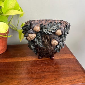 May include: A set of three ceramic mugs with a speckled, matte finish. The mugs are in shades of cream, light gray, and dark gray. Each mug has a simple, minimalist design, perfect for coffee or tea.