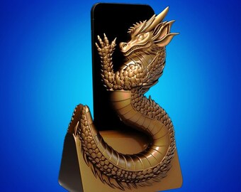 May include: A gold-coloured dragon-shaped phone stand. The dragon is intricately detailed, with a long body and a head that supports a black phone. The stand has a triangular base and a blue gradient background.