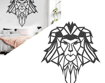 May include: Geometric lion head wall art in dark gray. The lion's face is constructed from angular shapes, creating a modern, artistic design. This metal wall decor adds a bold statement to any room. The artwork is displayed on a white wall.