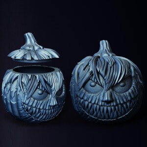 May include: Two gray, detailed, Halloween pumpkin carvings. One pumpkin is open and the other is closed. Both pumpkins have a scary, toothy grin.
