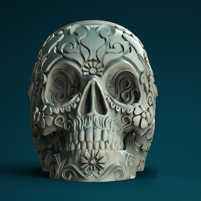 May include: A white sugar skull with intricate floral designs carved into the surface. The skull is a traditional symbol of Day of the Dead.