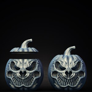 May include: Two silver Halloween pumpkins with scary faces carved into them. One pumpkin is open and the other is closed.