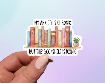 May include: A sticker with a watercolor illustration of a bookshelf filled with colorful books and a small potted plant. The text on the sticker reads "My anxiety is chronic but this bookshelf is iconic."
