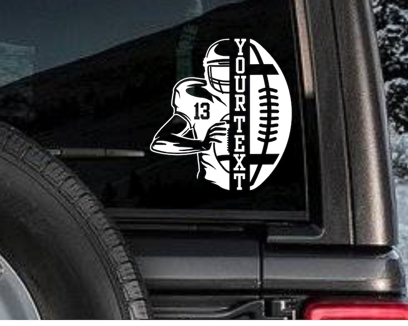 May include: Black and white decal of a football player running with a football and the text "YOUR TEXT" on a car window.