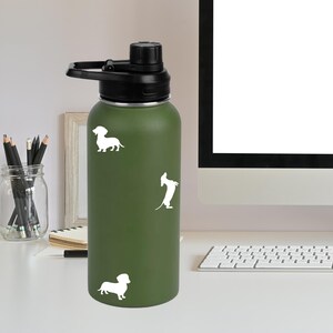 May include: A green stainless steel water bottle with a black lid and three white dachshund silhouettes.
