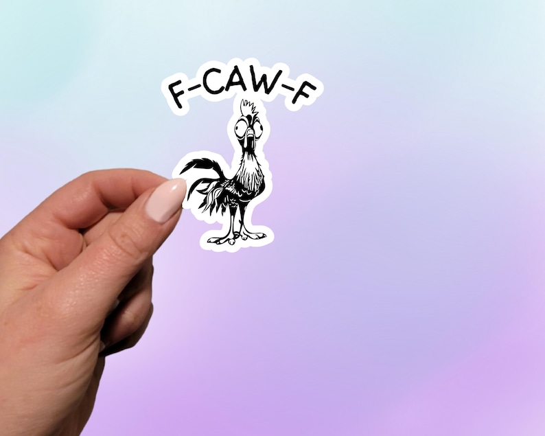 May include: A black and white sticker featuring a cartoon rooster with the text "F-CAW-F" above it. The rooster has a surprised expression and is standing on its feet. The sticker is held by a hand against a pastel gradient background.