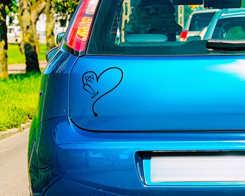 May include: A blue car with a black heart sticker that says "RN" inside the heart. The heart is formed by a stethoscope.