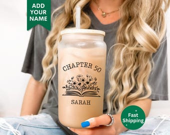 May include: A clear reusable tumbler with a black and white design of a book with flowers and the text "Chapter 50 Sarah".