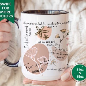 May include: White ceramic mug with a black rim and handle. The mug features a floral design with pink and yellow flowers and inspirational quotes with bible verses. The mug is available in 11oz and 15oz sizes and is dishwasher safe.