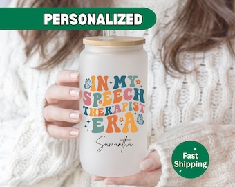 May include: A white, personalized, reusable water bottle with a bamboo lid and a straw. The bottle has a colorful graphic that says "In My Speech Therapist Era" with a butterfly and stars. The name "Samantha" is written below the graphic.