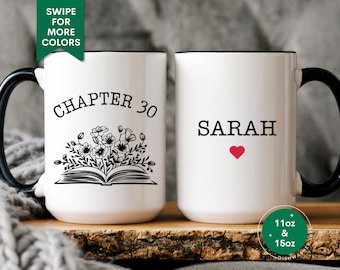 May include: Two white ceramic mugs with black handles and black rims. The mug on the left has a black and white illustration of a book with flowers and the text "Chapter 30". The mug on the right has the name "SARAH" in black text with a red heart below it. Both mugs are 11 oz and 15 oz.
